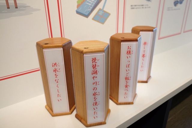Traditional fortune-telling boxes, which when shaken upside-down dispense sticks with fortunes written on them.